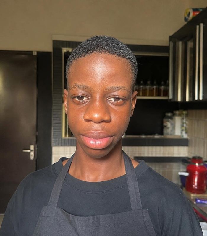 Isaiah cooking in the kitchen