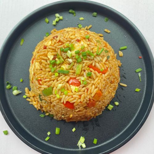 Plated egg fried rice topped with spring onions